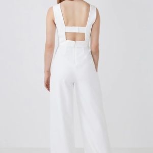 BCBG jumpsuit made from stretch crepe. Cutout open back with covered bra strap.